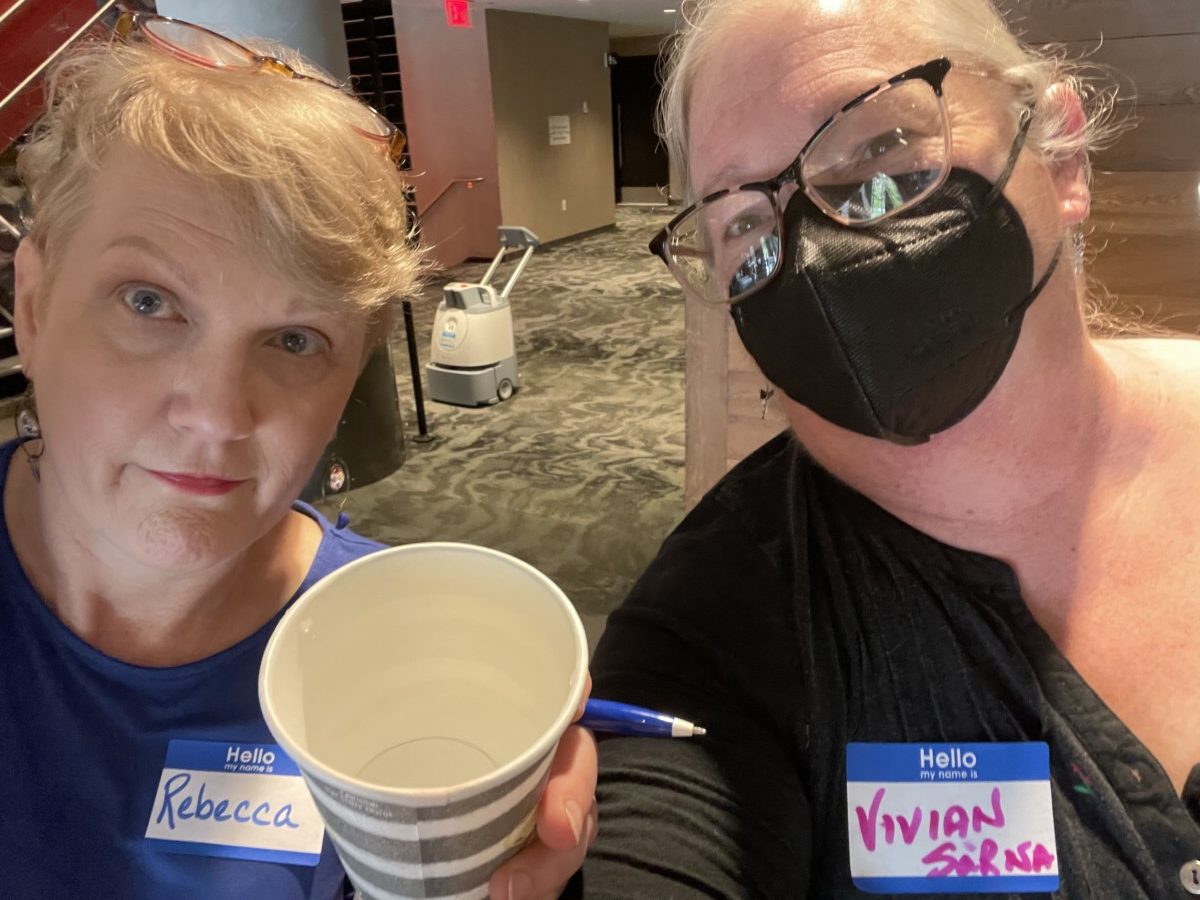 Rebecca Davis and Vivian Sarna, holding a cup of water